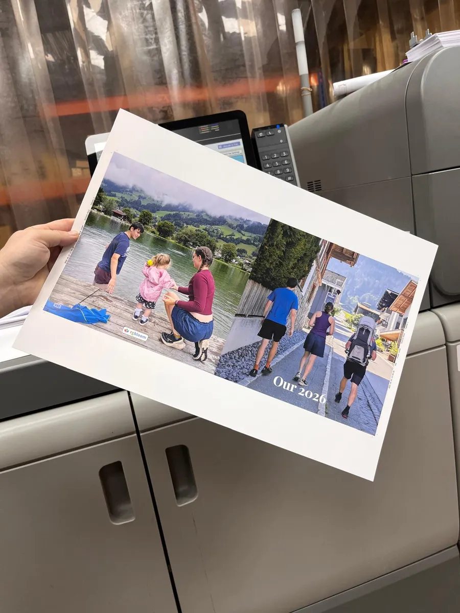 The printed cover sheet held up beside the press