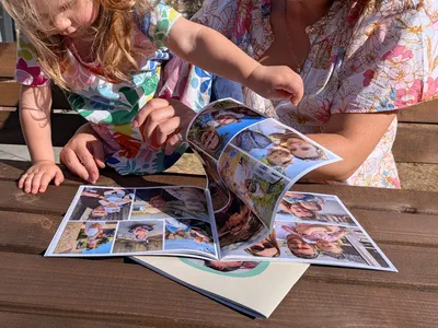 Hands flicking through a printed book, a page arched up mid-turn